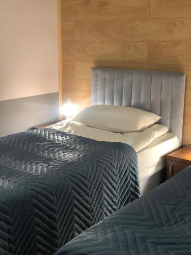 two beds sitting next to each other in a bedroom at Samal-2 Hotel in Almaty