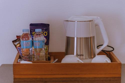 a wooden shelf with a blender and drinks on it at Thistle Inn in Panglao