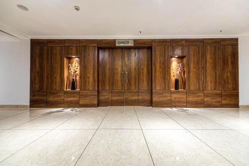 a large room with wooden doors and a tile floor at The Elite Lucknow Convention Hotel in Lucknow