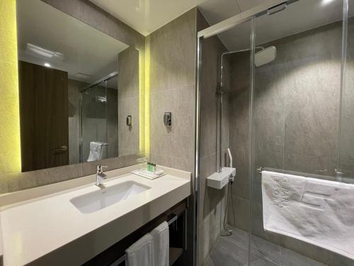 a bathroom with a sink and a shower at Mudeung Park Hotel in Gwangju