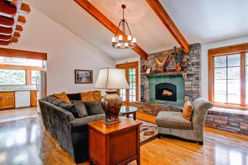 
a living room filled with furniture and a fireplace at Ahwahnichi Lodge in Yosemite West
