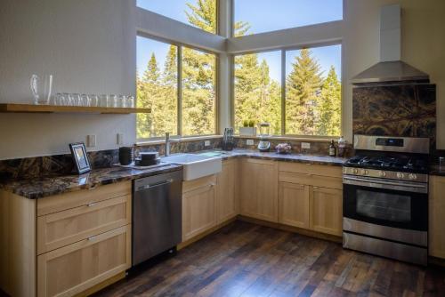 a kitchen with wooden cabinets and a large window at Alpenglow 3 in Yosemite West