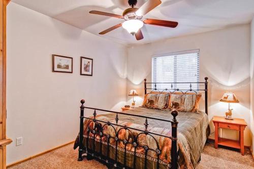 a bedroom with a bed with a ceiling fan at Bears Den & Little Bear in Yosemite West
