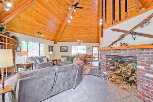 a living room with a brick fireplace in a house at Coyote Creek in Yosemite West