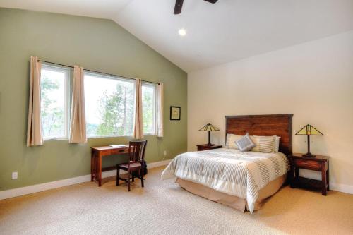 a bedroom with a bed and a desk and windows at Eureka in Yosemite West