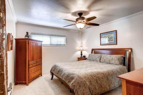 a bedroom with a bed and a ceiling fan at Fishermen’s Oasis in Oakhurst