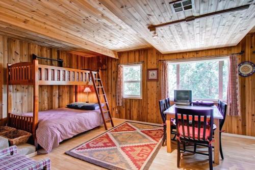 a bedroom with a bunk bed and a desk with a computer at Edelweiss in Yosemite West
