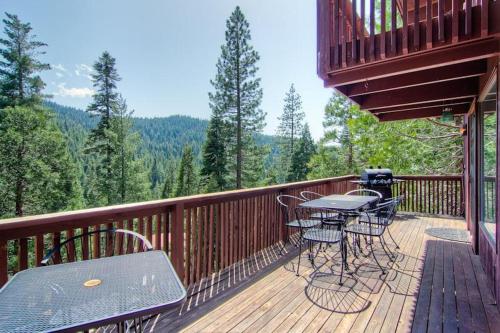 a balcony with a table and chairs on a deck at Edelweiss in Yosemite West