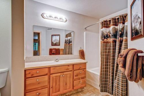 a bathroom with a sink and a mirror and a tub at Explorers Retreat in Yosemite West