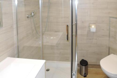 a shower with a glass door in a bathroom at Terraced Houses, Dziwnow in Dziwnów