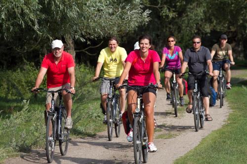 a group of people riding bikes down a trail at Domy na Wodzie na Mazurach in Pisz