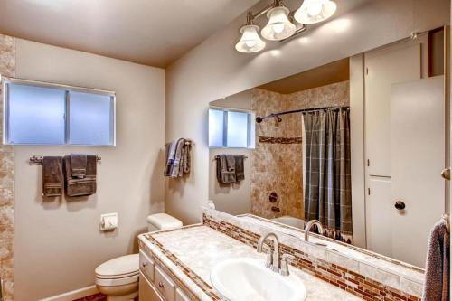 a bathroom with a sink and a toilet and a mirror at Lazy Bear Lodge in Oakhurst