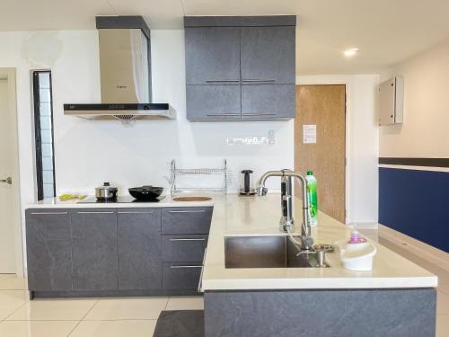 a kitchen with a sink and a counter top at Midvalley Southkey Mosaic Suite by Nest Home in Johor Bahru