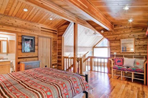 a bedroom with a bed in a log cabin at Red Fox Retreat in Yosemite West