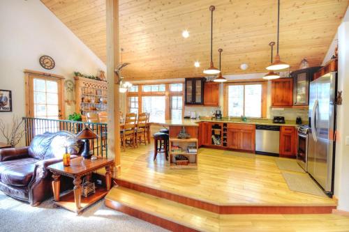 a large kitchen and living room with wooden ceilings at Strawberry Creek in Yosemite West