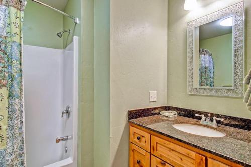 a bathroom with a sink and a shower with a mirror at Sequoias West in Yosemite West