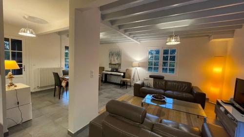 a living room with a couch and a table at Cool Landes in Sainte-Eulalie-en-Born