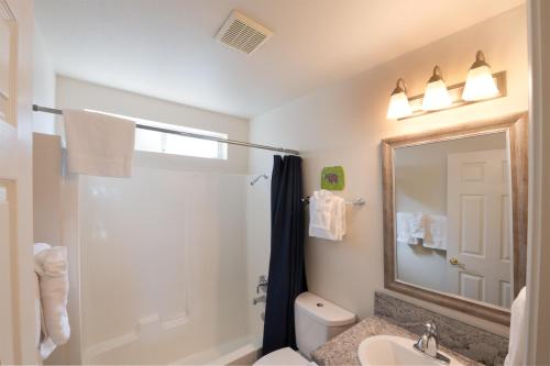 a bathroom with a shower and a sink and a mirror at Yosemite Park Place in Yosemite West