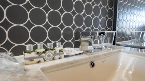 a bathroom counter with a sink and a mirror at Lavalse Hotel in Busan
