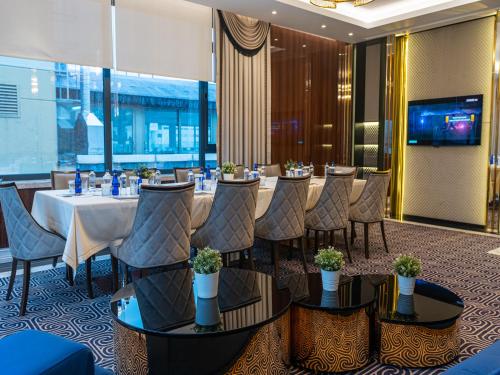 a restaurant with a long table and chairs in a room at Ilci Residence Hotel in Ankara