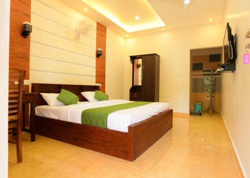 a bedroom with a large bed in a room at ANNUS HOMESTAY RAMAKKALMEDU in Ramakkalmedu