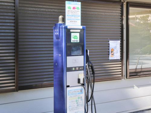 a blue fueling machine in front of a building at Yumeno Onsen in Kami