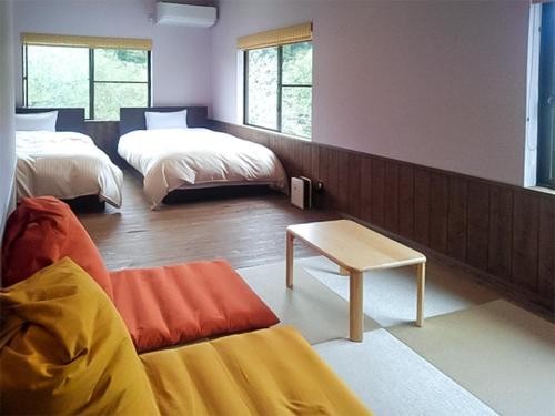 Postel nebo postele na pokoji v ubytování Yumeno Onsen