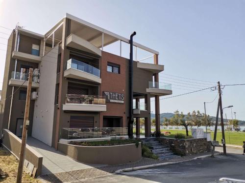 a large building with stairs in front of it at Thetis Boutique Apartments in Neos Marmaras