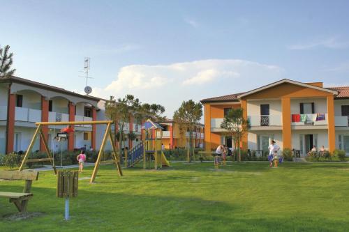a group of people playing in a park at Pini Village Lido Altanea in Caorle