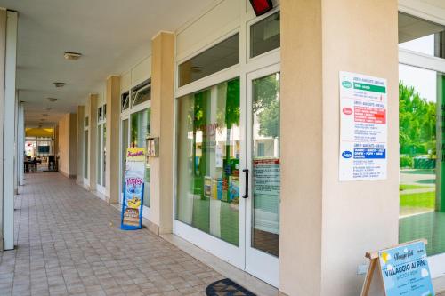 a hallway of a shopping mall with glass windows at Pini Village Lido Altanea in Caorle