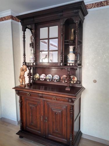 a large wooden cabinet in the corner of a room at Apartament Jasiu in Ustka
