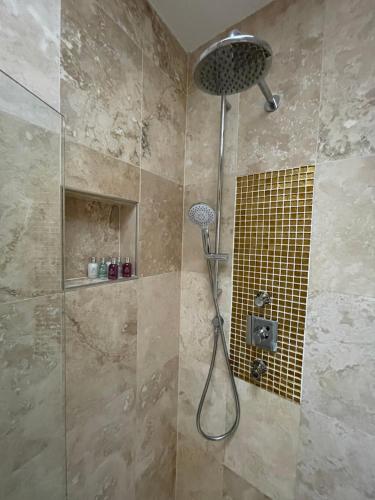 a shower with a shower head in a bathroom at 4 Islington Park Street in London