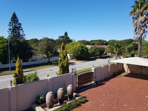 a fence next to a street with a road at Winchester Place in Port Elizabeth
