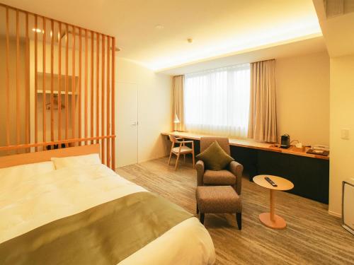 Ένα ή περισσότερα κρεβάτια σε δωμάτιο στο Hotel Yutoria Fujisato
