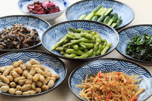 a group of bowls filled with different types of food at Boso Shirahama Umisato Hotel in Minamiboso