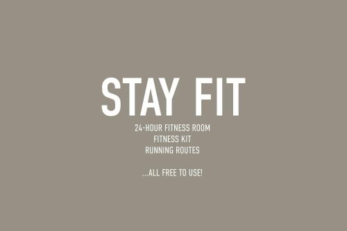a poster with the words stay fit and aoliberal fitness at Apartments by Brøchner Hotels in Copenhagen