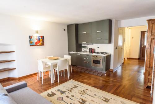 a living room with a table and a kitchen at DeTillierStudiò in Aosta