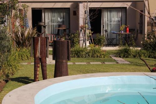 a swimming pool in front of a house at Mirabel Guesthouse in Parys