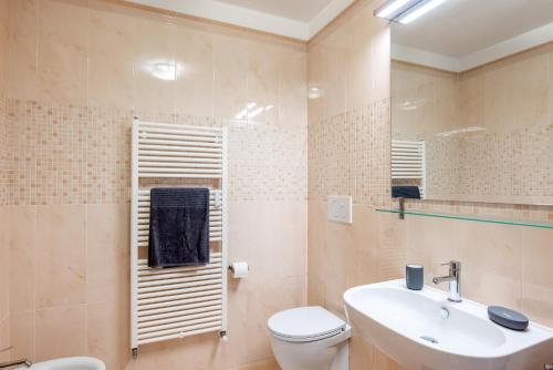 a bathroom with a white toilet and a sink at Santa Rita Roomy Apartments in Padova