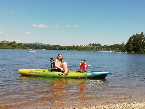 a woman and a child in a kayak on a lake at Lipno Club in Frymburk