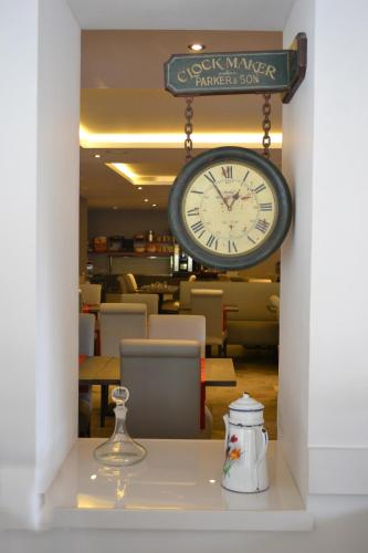 a clock hanging above a table in a restaurant at La Table de Gustave in Ornans