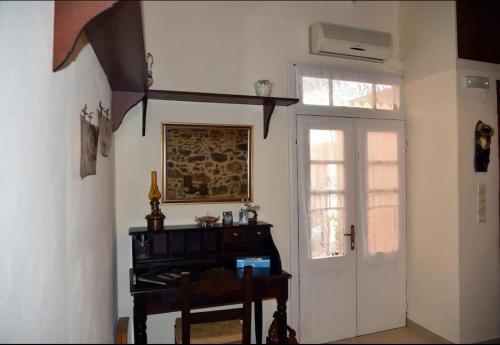 a room with a door and a piano and a window at Traditional Residence with terrace in Latsídha