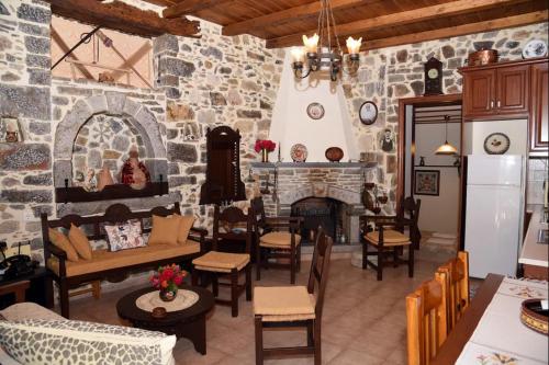 a living room with a stone wall with a fireplace at Traditional Residence with terrace in Latsídha