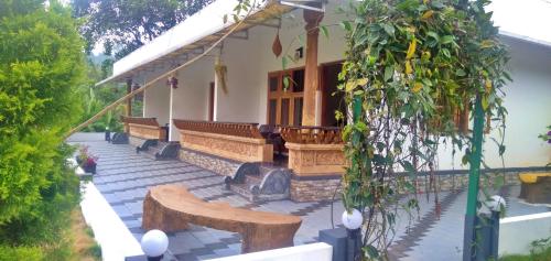 a building with benches on a patio at Wild Mist Homestay in Munnar