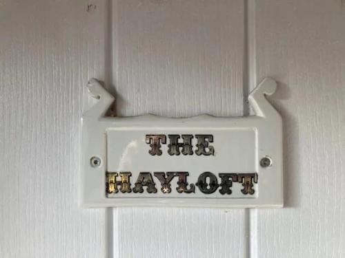 a sign that reads the mayot hanging on a door at The Hayloft in Abergavenny
