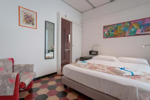 a hotel room with a bed and a chair at Casa Diaz in Cagliari