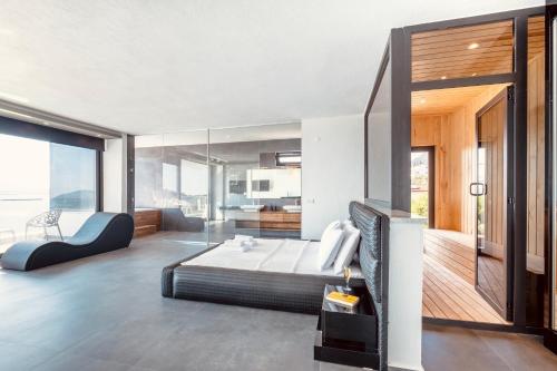 a bedroom with a large bed and a balcony at Luxury Villa for 8 with 20m large Infinity Pool in Kalkan in Kaş