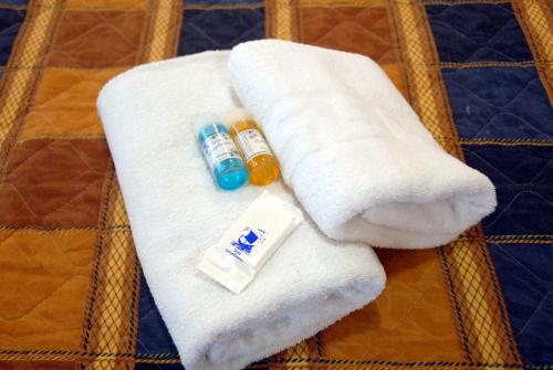 a pile of towels and medicines on a chair at Tzovanna Studios in Loutra Edipsou