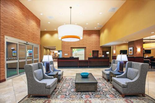 a lobby with chairs and a table and a waiting room at Holiday Inn Ardmore by IHG in Ardmore