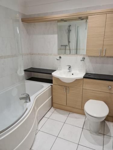 a bathroom with a sink and a tub and a toilet at Tees Valley Apartments in Middlesbrough